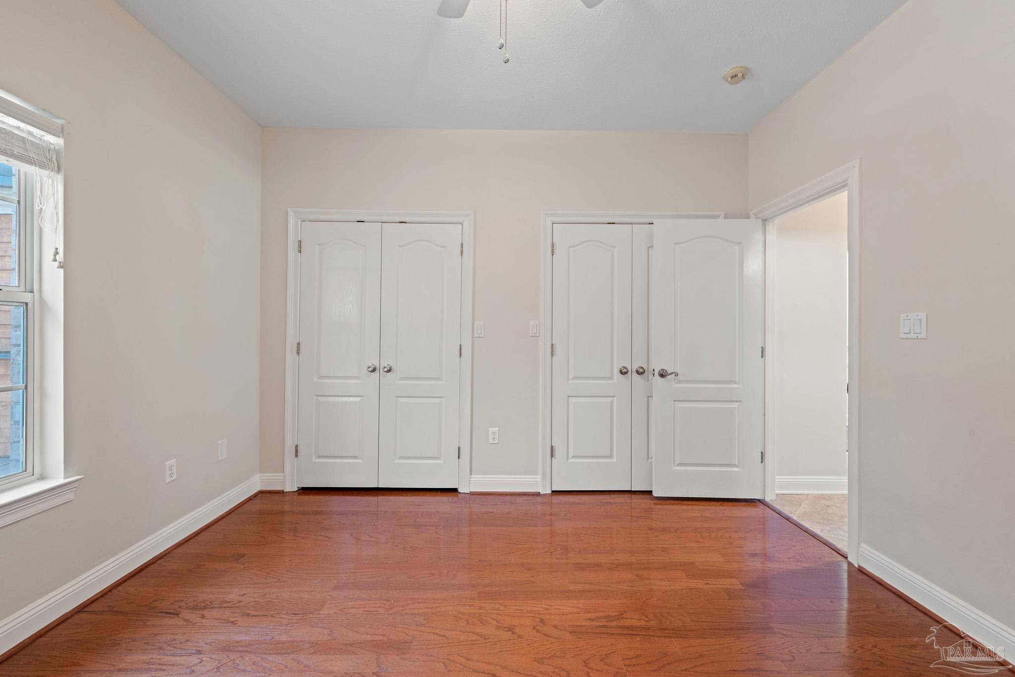 4149 Chartwell Street Pace, FL 32571 - Photo 29 of 49 a view of an empty room with wooden floor