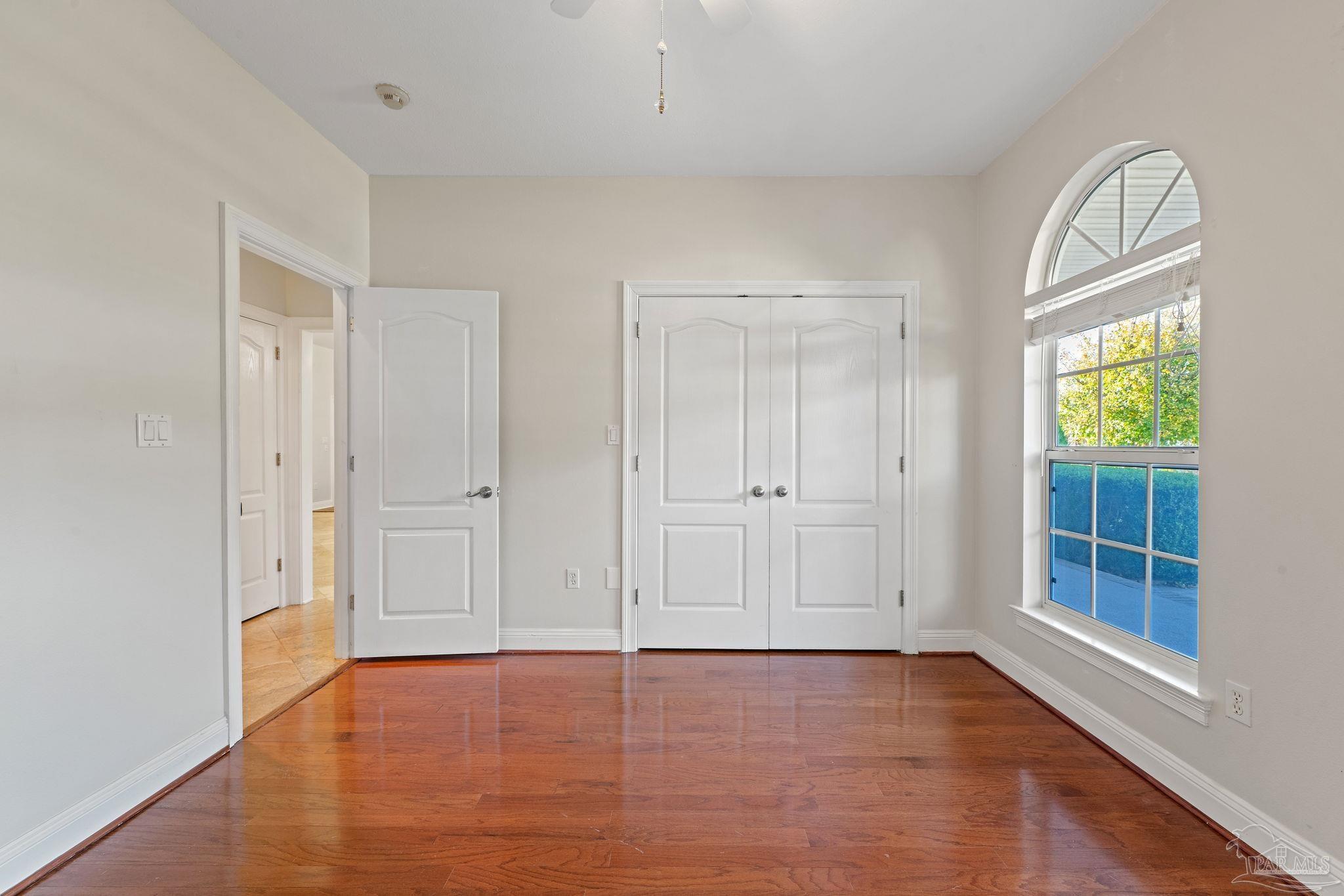 4149 Chartwell Street Pace, FL 32571 - Photo 31 of 49 an empty room with window and wooden floor