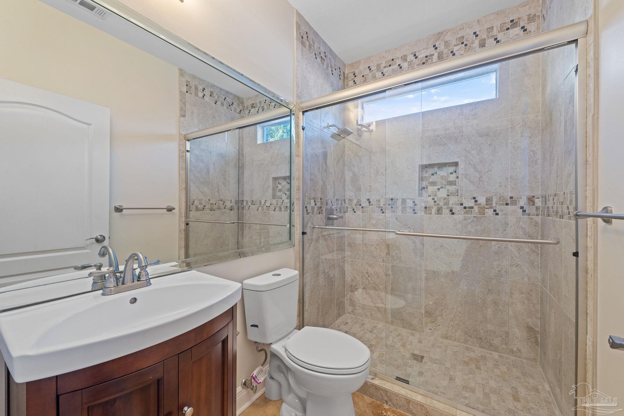 4149 Chartwell Street Pace, FL 32571 - Photo 32 of 49 a bathroom with a sink toilet and shower