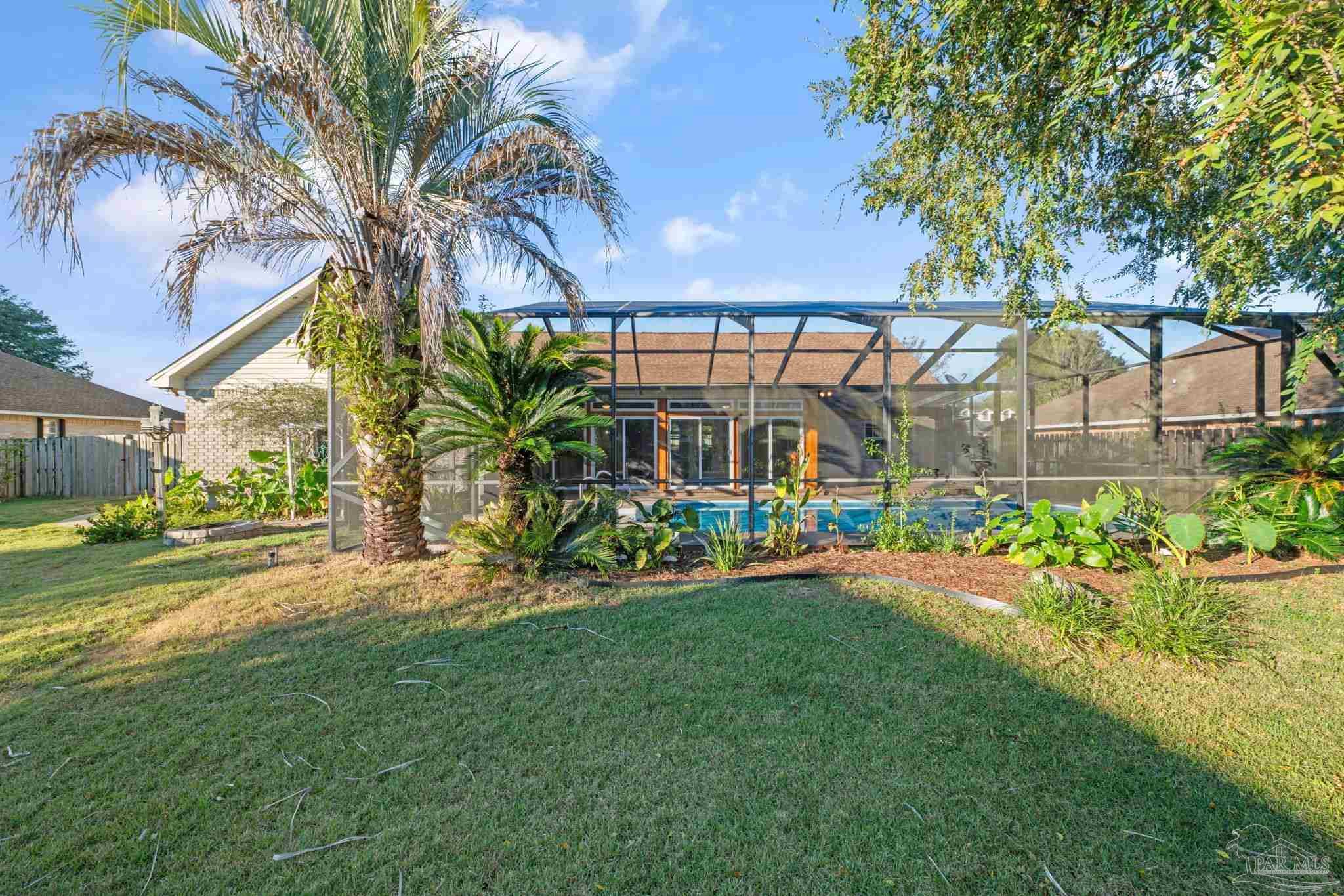 4149 Chartwell Street Pace, FL 32571 - Photo 47 of 49 a front view of a house with garden