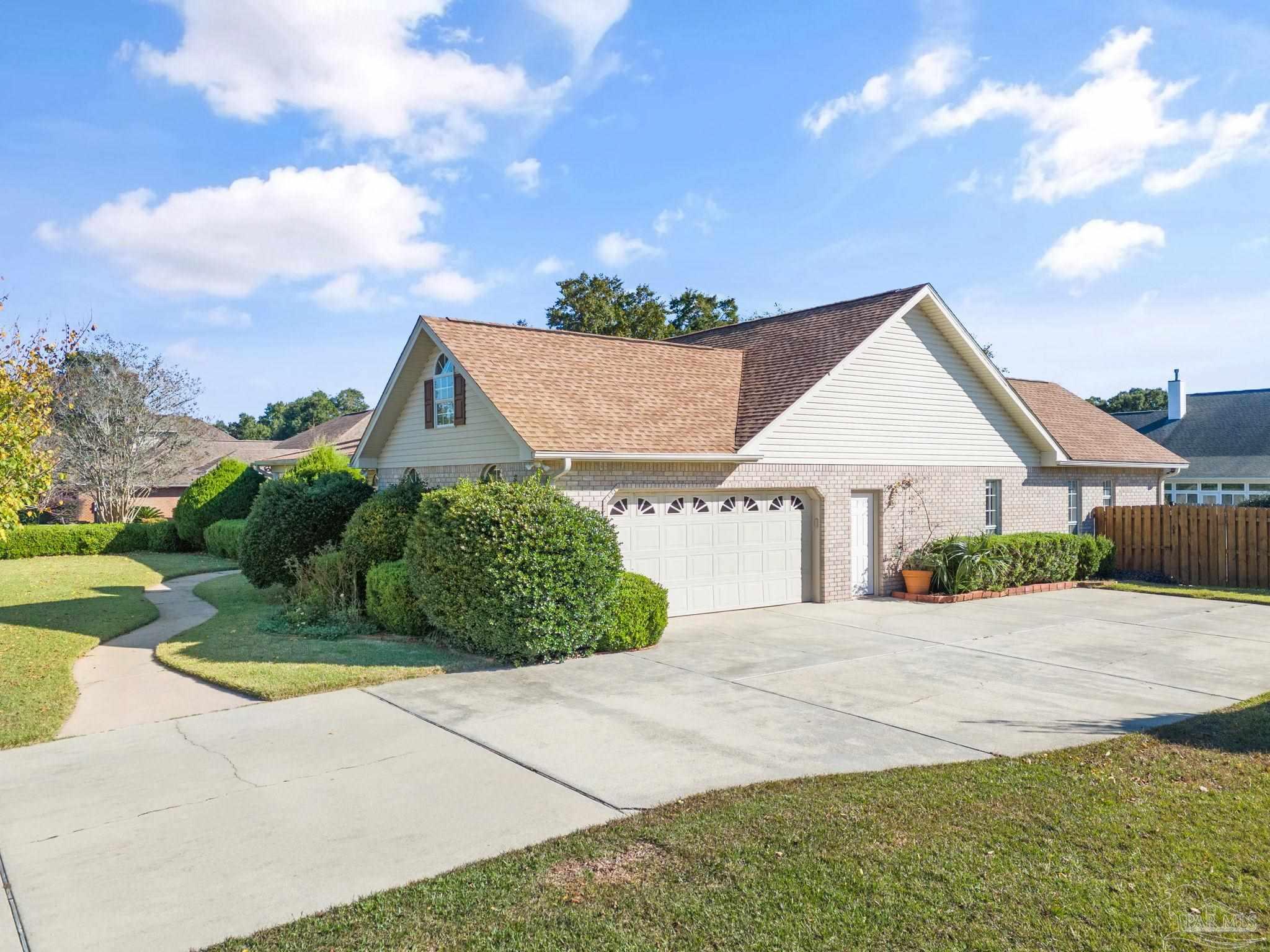 4149 Chartwell Street Pace, FL 32571 - Photo 49 of 49 a front view of a house with a yard and garage