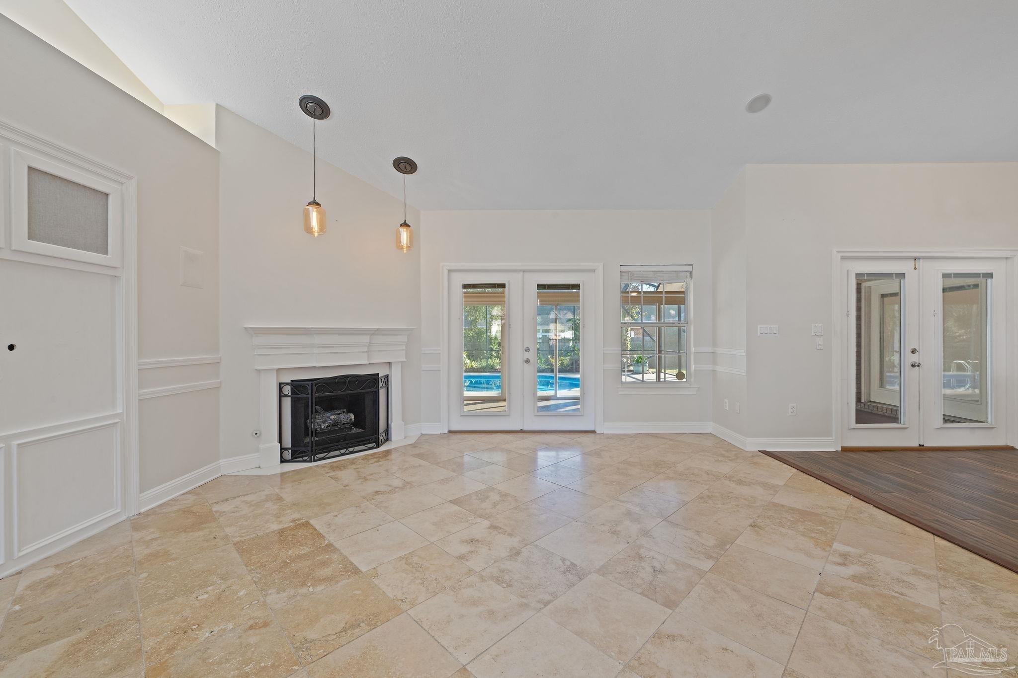 4149 Chartwell Street Pace, FL 32571 - Photo 6 of 49 a view of an empty room with a fireplace and a window