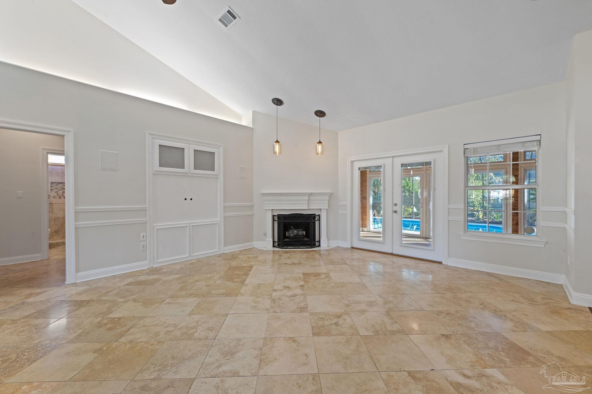4149 Chartwell Street Pace, FL 32571 - Photo 7 of 49 a view of an empty room with window and fire place