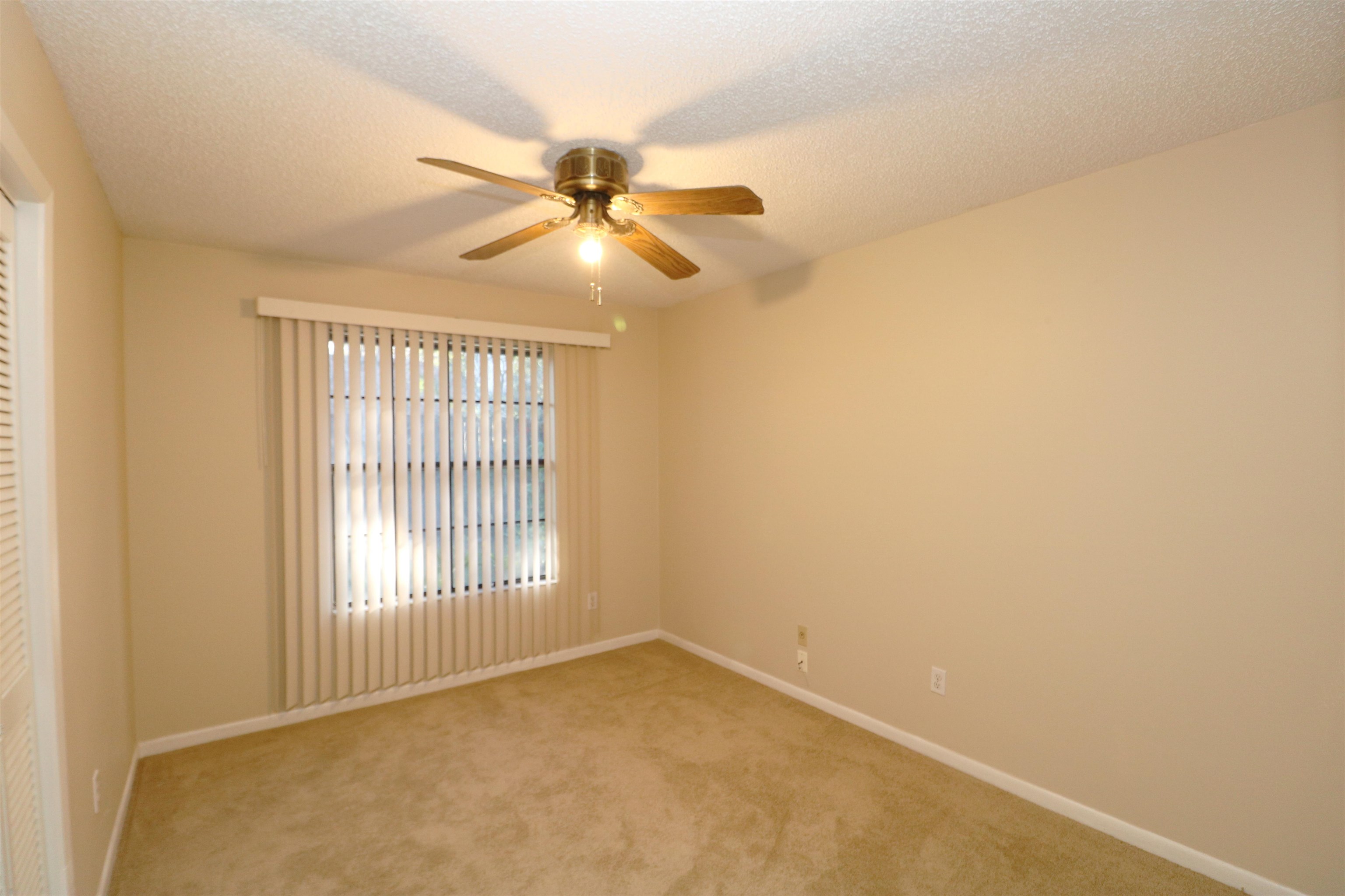 222 Jasmine Road St. Augustine, FL 32086 - Photo 11 of 30 an empty room with windows and fan