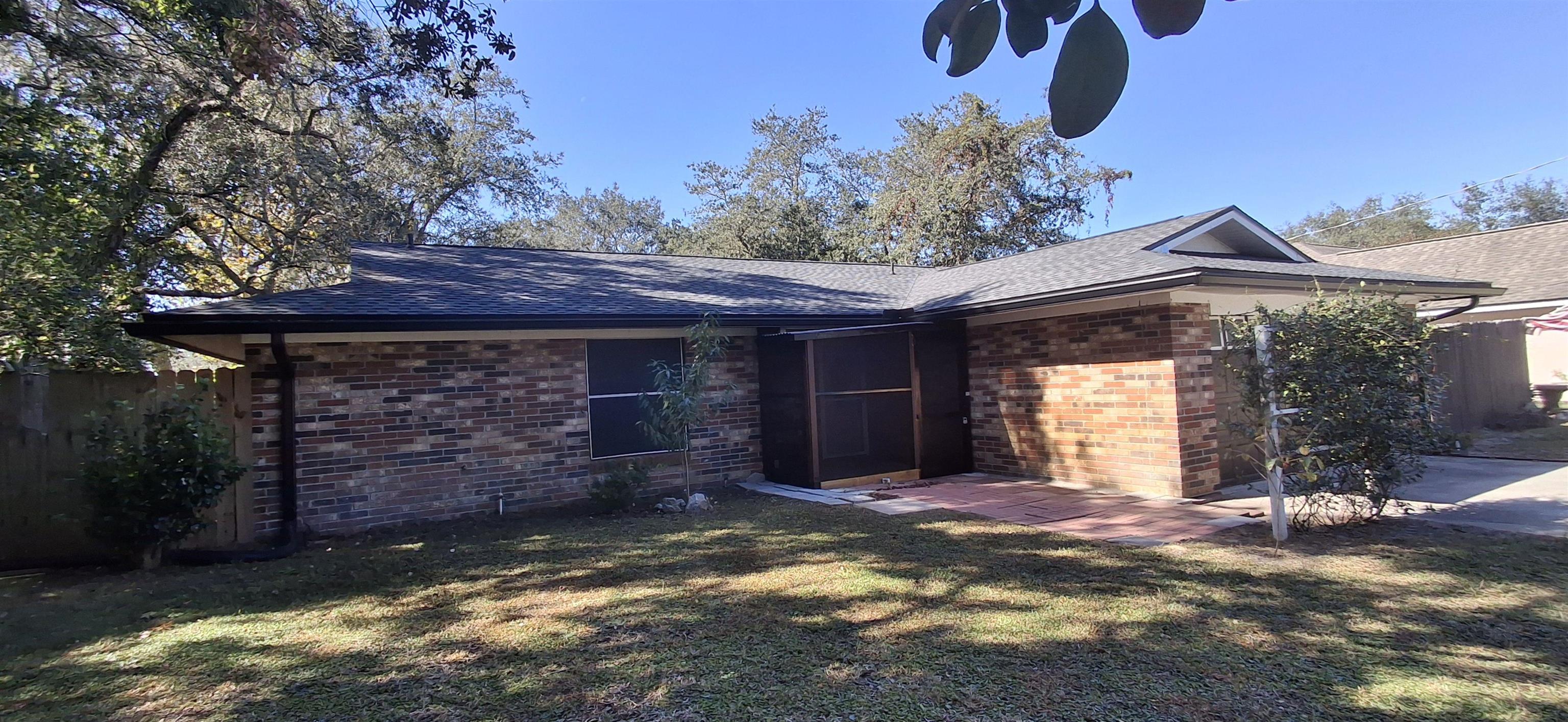 222 Jasmine Road St. Augustine, FL 32086 - Photo 2 of 30 a view of a house with a small yard and a large tree