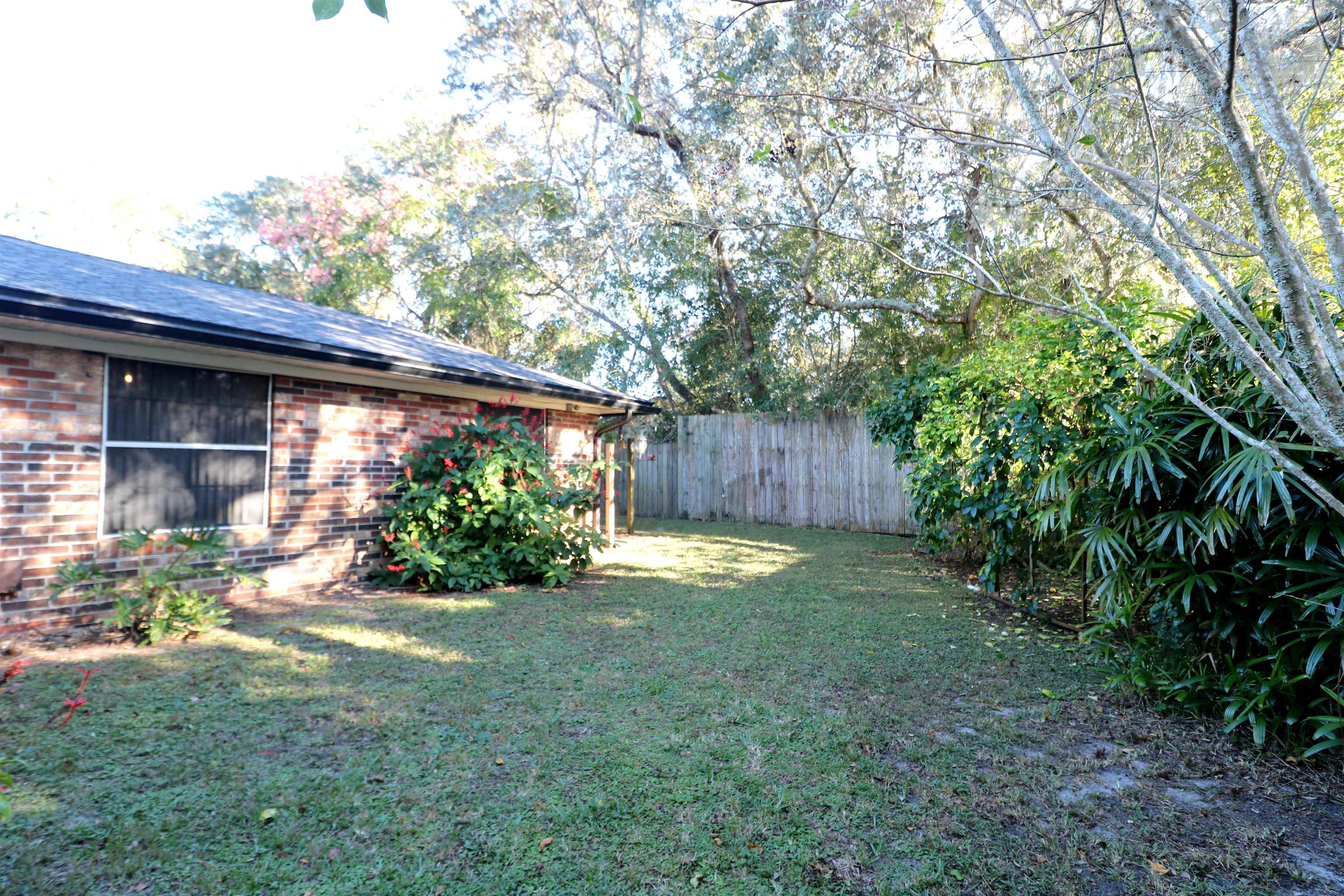 222 Jasmine Road St. Augustine, FL 32086 - Photo 27 of 30 a view of backyard with wooden fence and large trees