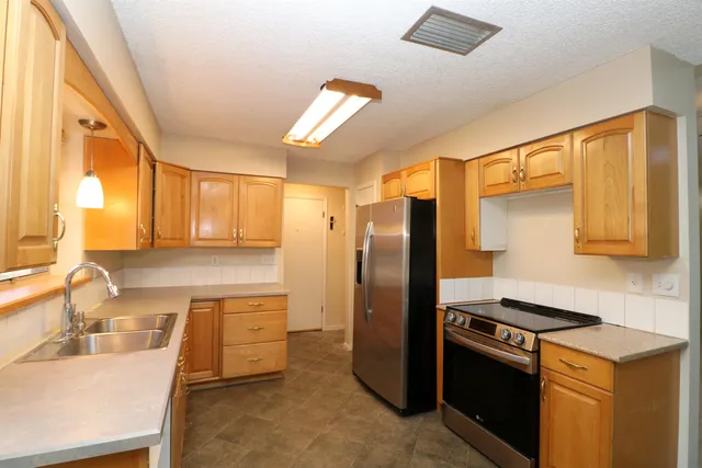 a kitchen with a refrigerator and a sink