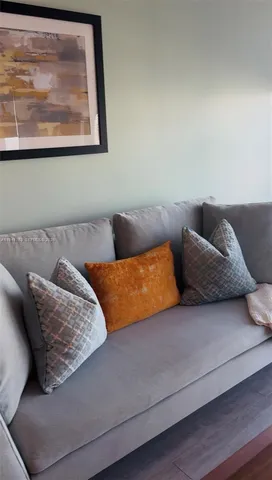 a living room with furniture and painting on the wall