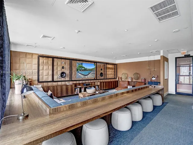 a living room with furniture pool table and a large window