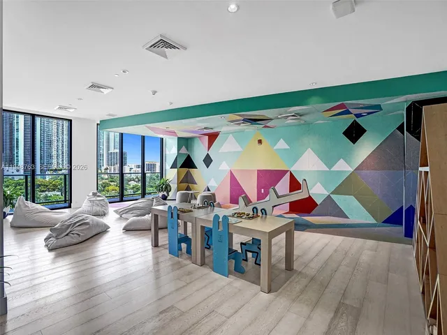 a view of a livingroom with furniture and floor to ceiling window