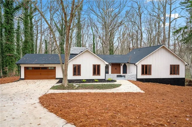 a front view of house with yard and trees