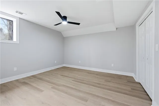a view of a house with a yard and wooden fence