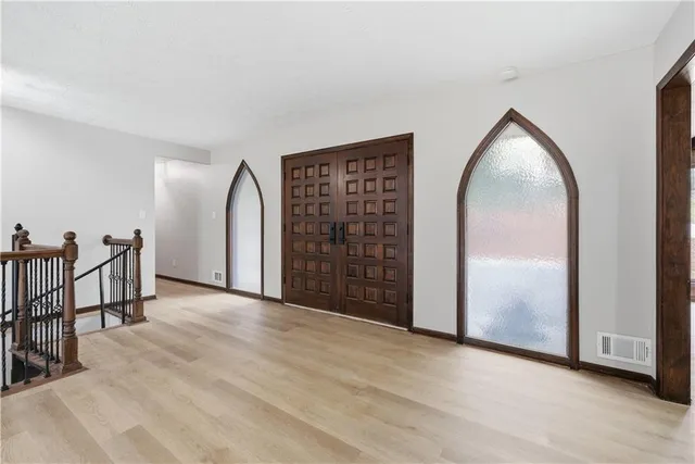 a kitchen that has a sink a counter space and stainless steel appliances
