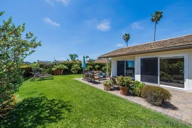 a front view of a house with porch and garden