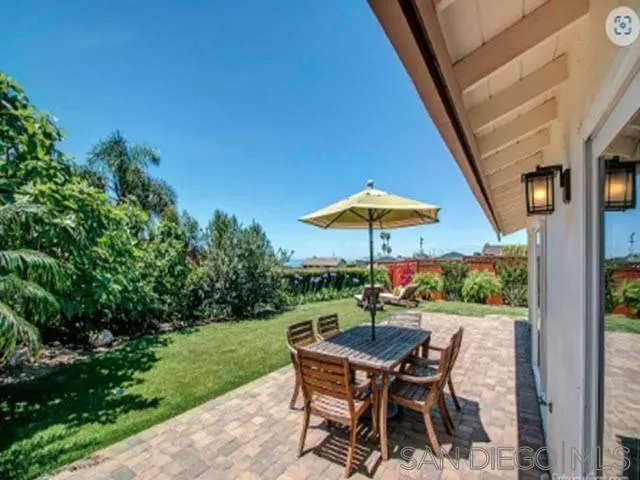 a view of backyard with seating space and trees