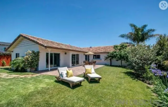 a view of a house with backyard porch and sitting area