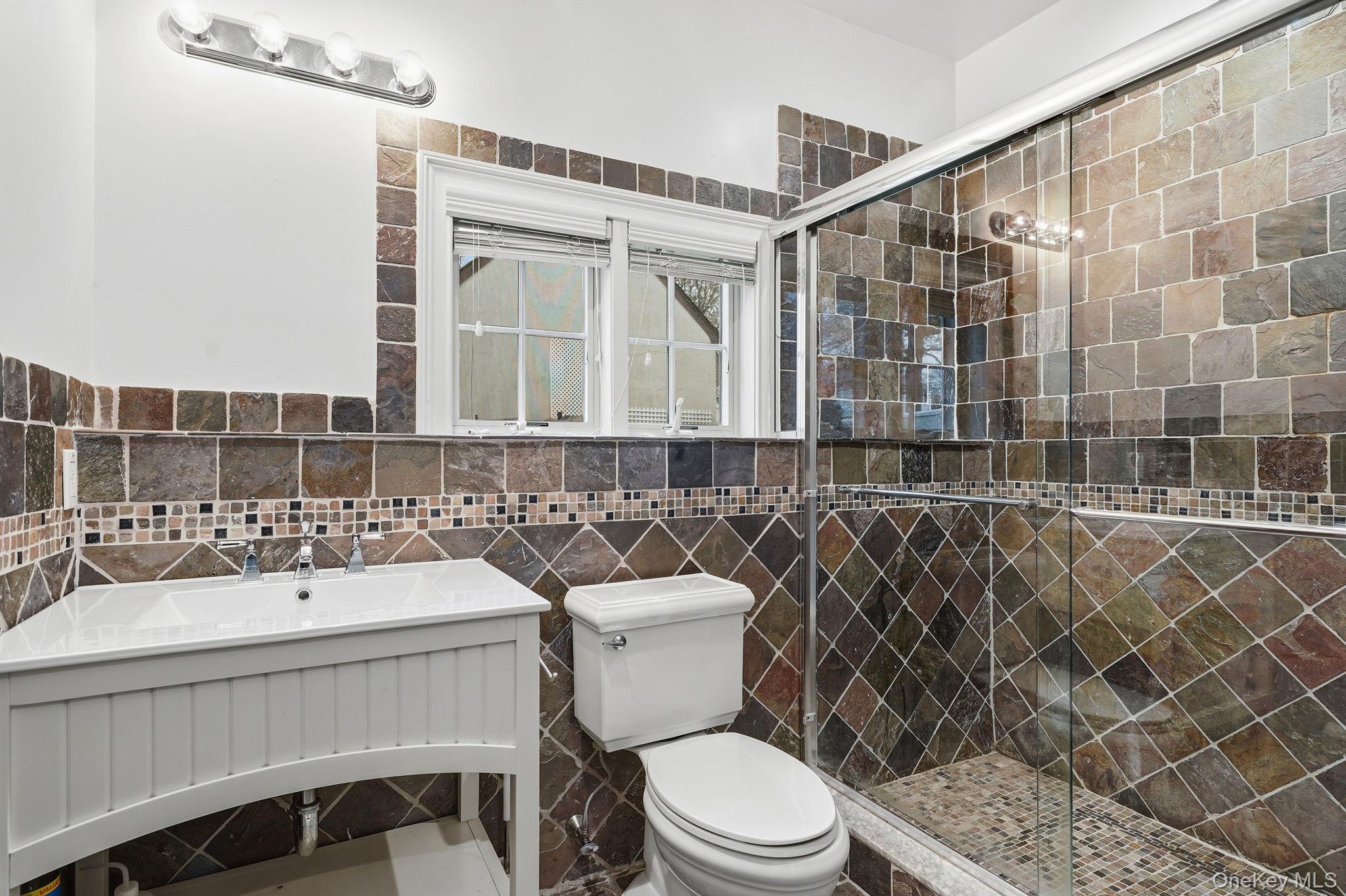 228 Central Avenue Rye, NY 10580 - Photo 20 of 24 a bathroom with a sink mirror toilet and shower