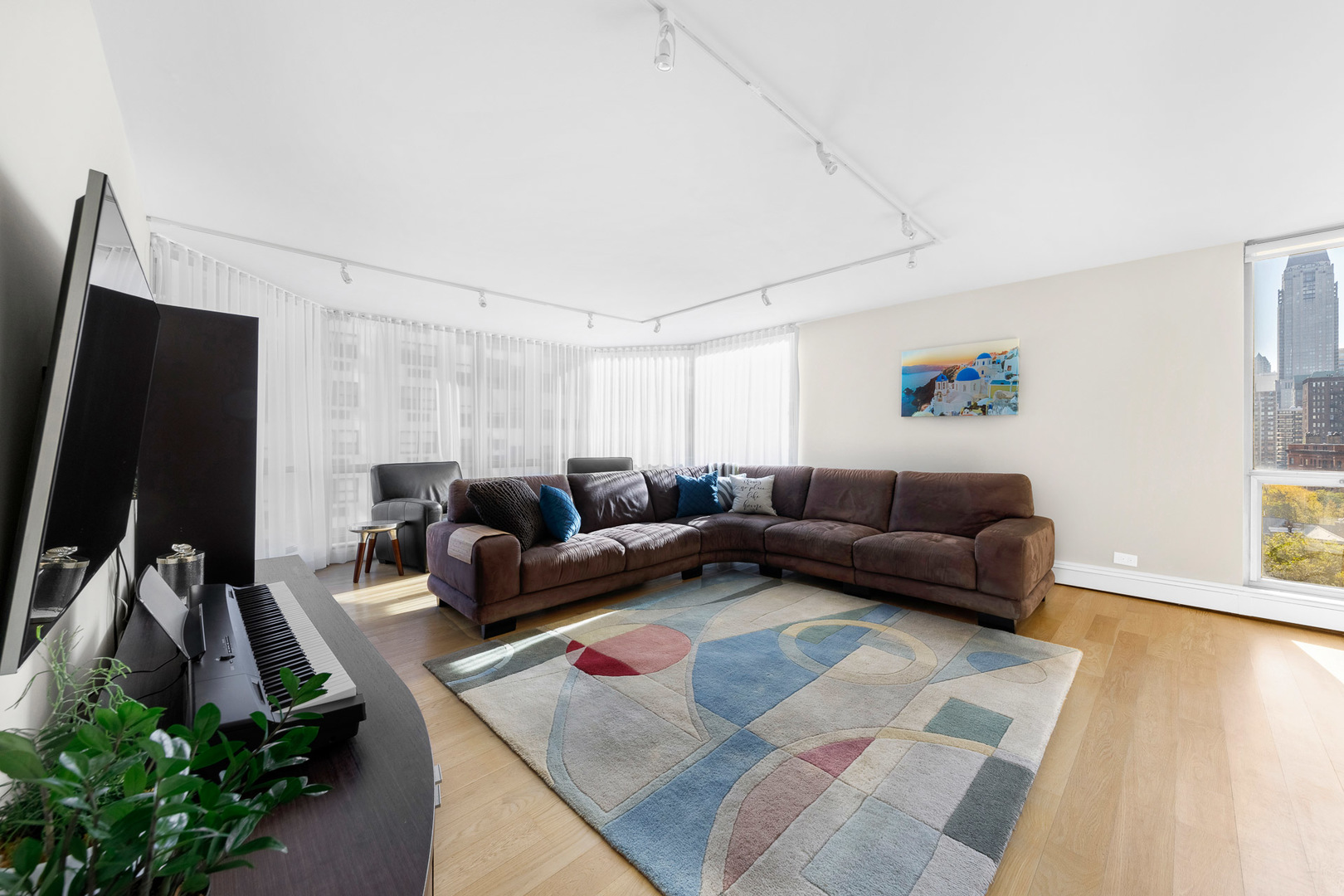 1310 North Ritchie Court, Unit 11C Chicago, IL 60610 - Photo 2 of 21 a living room with furniture and a flat screen tv