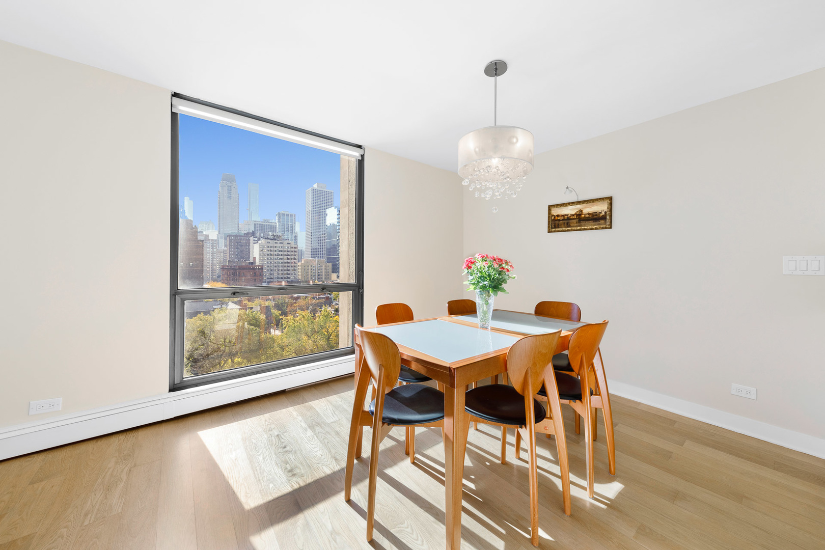 1310 North Ritchie Court, Unit 11C Chicago, IL 60610 - Photo 4 of 21 a view of a dining room with furniture wooden floor and a chandelier