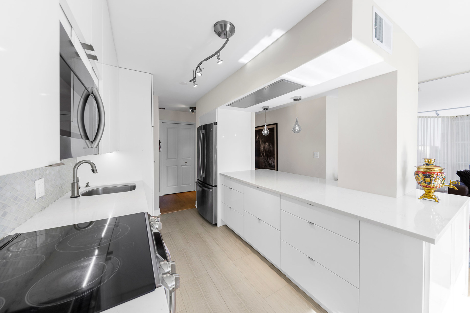 1310 North Ritchie Court, Unit 11C Chicago, IL 60610 - Photo 5 of 21 a large white kitchen with a large window