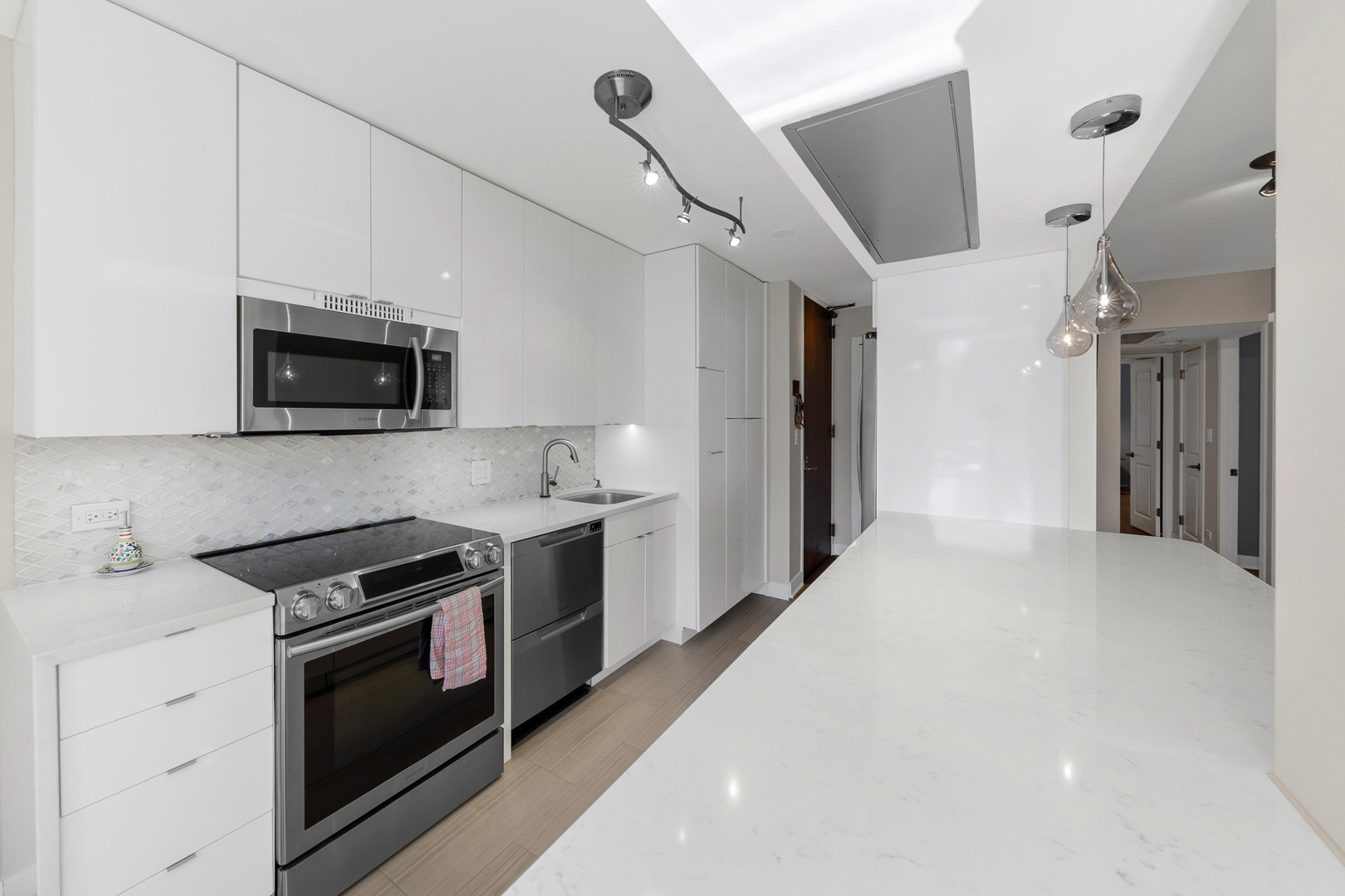 1310 North Ritchie Court, Unit 11C Chicago, IL 60610 - Photo 6 of 21 a kitchen with a stove and a microwave