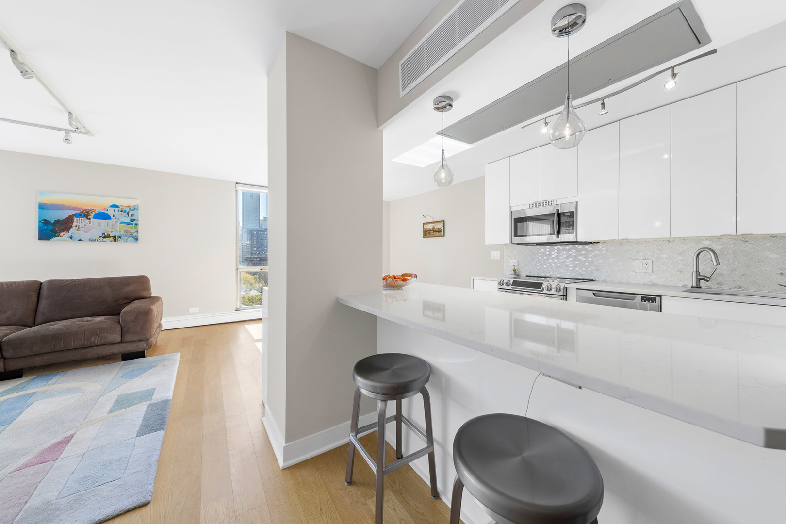 1310 North Ritchie Court, Unit 11C Chicago, IL 60610 - Photo 8 of 21 a kitchen with stainless steel appliances granite countertop a sink a stove a refrigerator cabinets and chairs