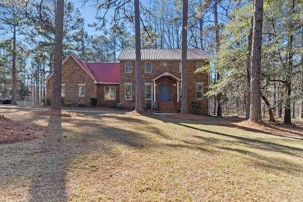a view of a yard and a house with a large tree