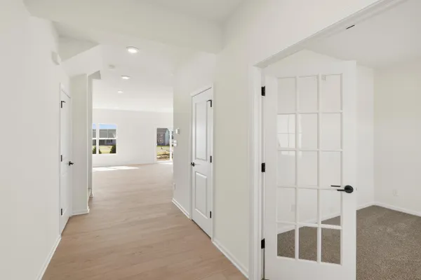 a view of a hallway with closet and front door