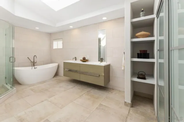a spacious bathroom with a double vanity sink and a mirror
