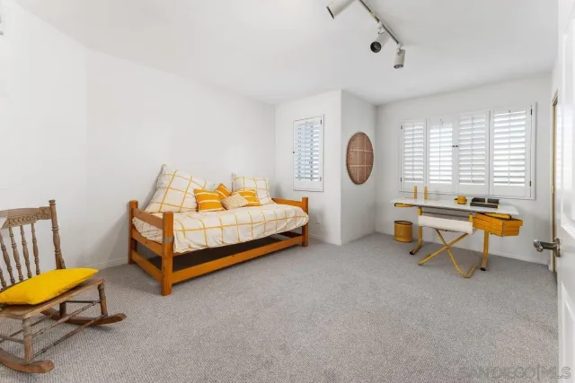 a bedroom with a bed and a lounge chair