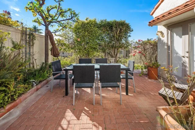 a view of a patio with table and chairs and potted plants