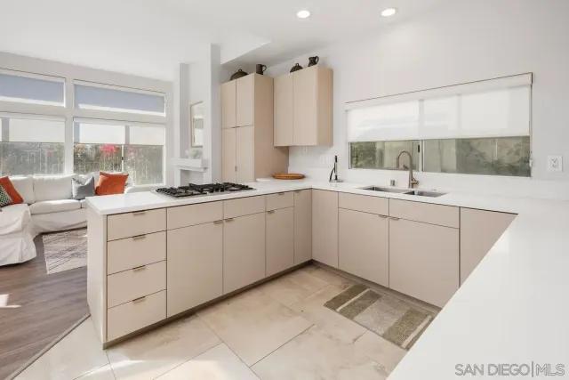 a kitchen with a sink window and cabinets