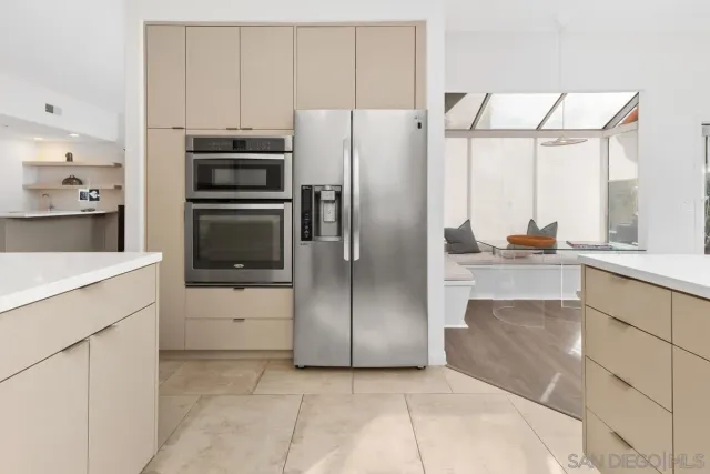 a kitchen with a refrigerator and a sink