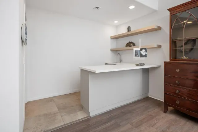 a kitchen with a sink a stove and cabinets