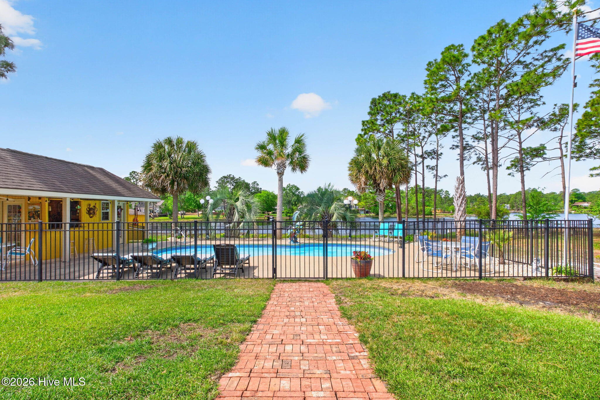 137 Ash Road Southport, NC 28461 - Photo 35 of 64 brick walkway to the incredible swimming pool, pool house complete with