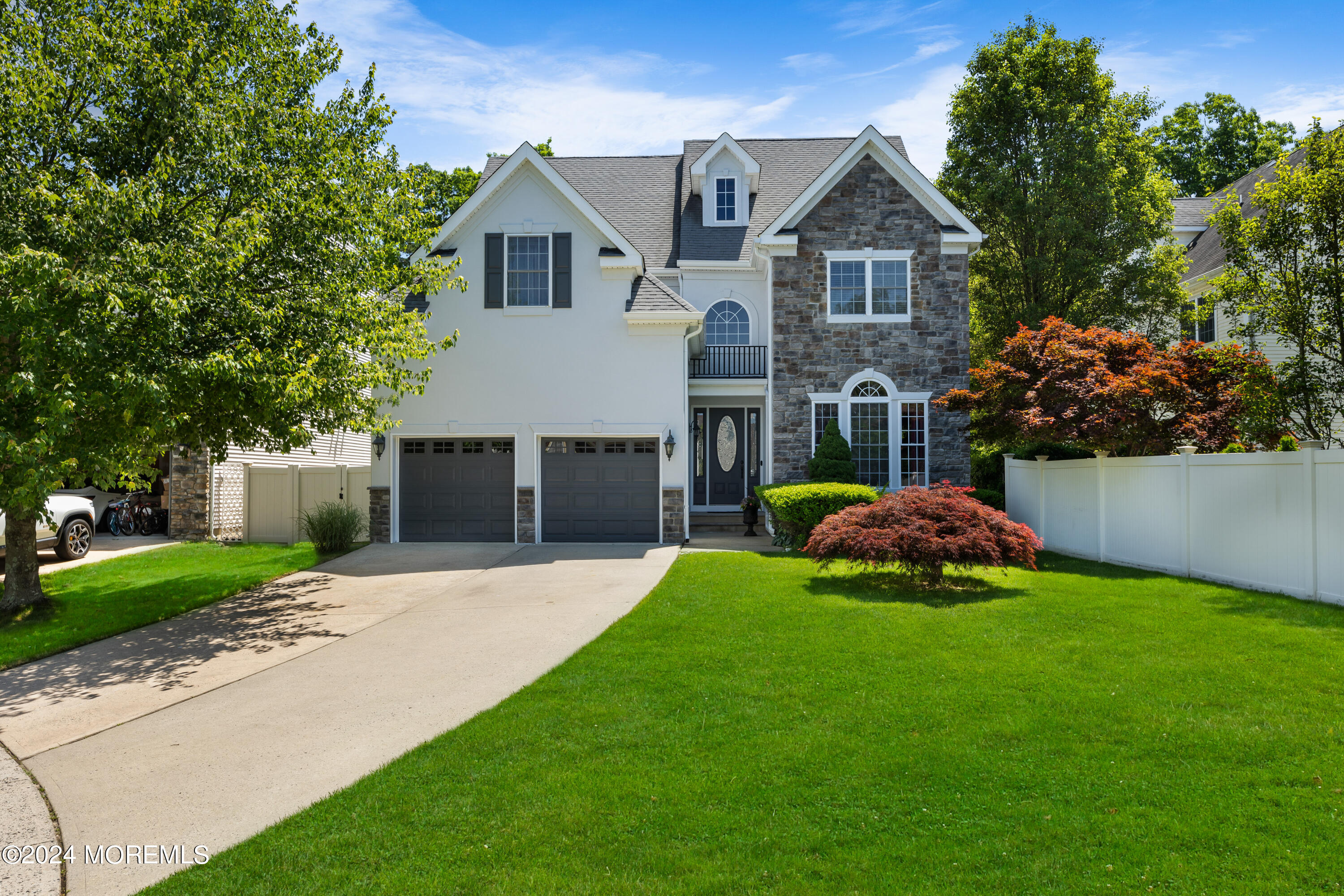 a front view of a house with a garden and yard