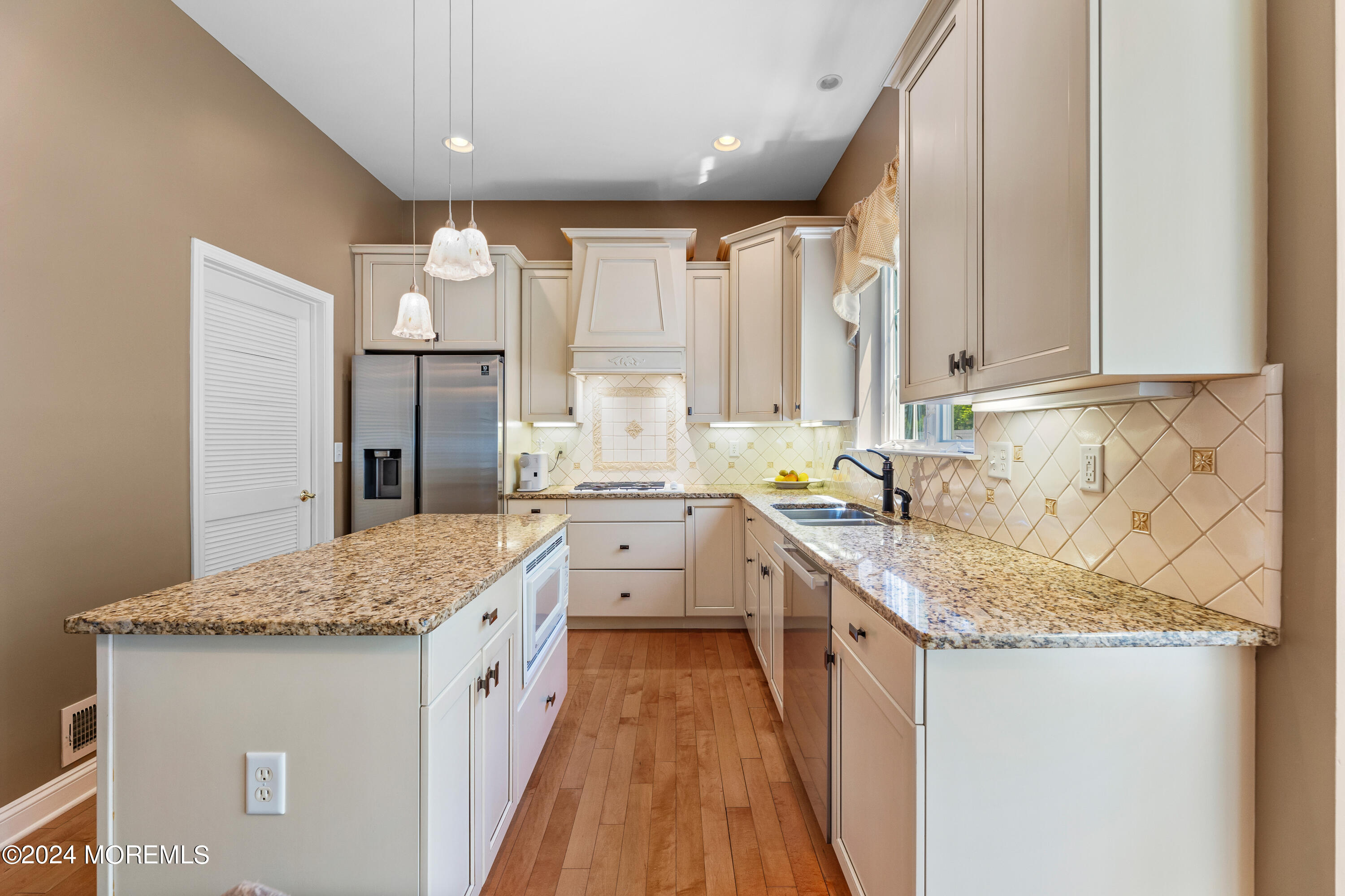 19 Rockspray Court Howell, NJ 07731 - Photo 16 of 37 a kitchen with granite countertop a sink stove and cabinets