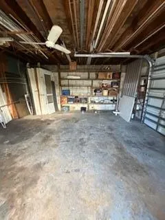 a view of an empty room with wooden ceiling