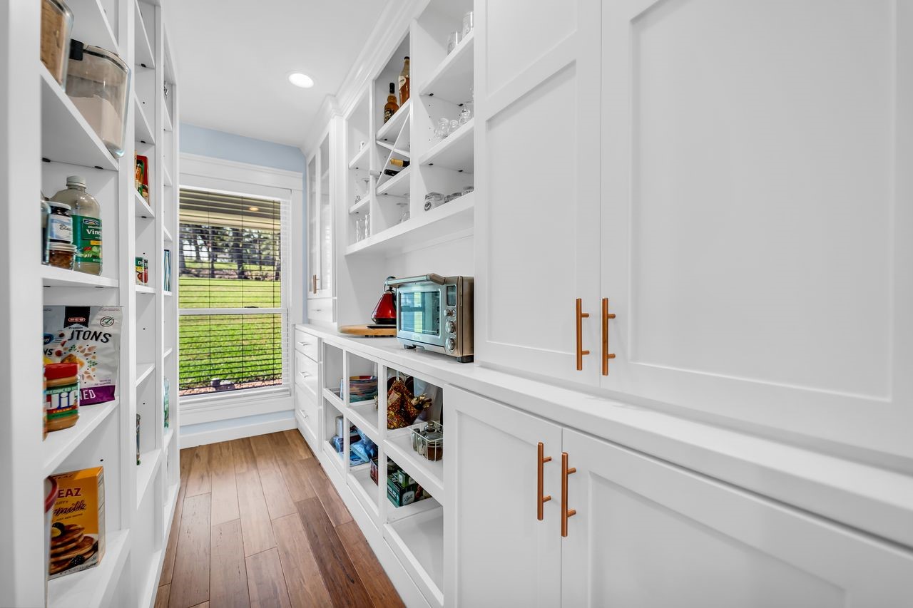 310 Cove Loop Coldspring, TX 77331 - Photo 19 of 48 Cabinets, shelves and a counter top makes this a stylish functional pantry offering lots of storage.
