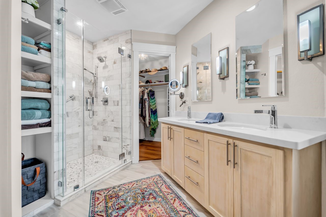 310 Cove Loop Coldspring, TX 77331 - Photo 22 of 48 The primary bathroom has been remodeled with a double vanity, frame less glass shower, heated flooring and 2 walk in closets.