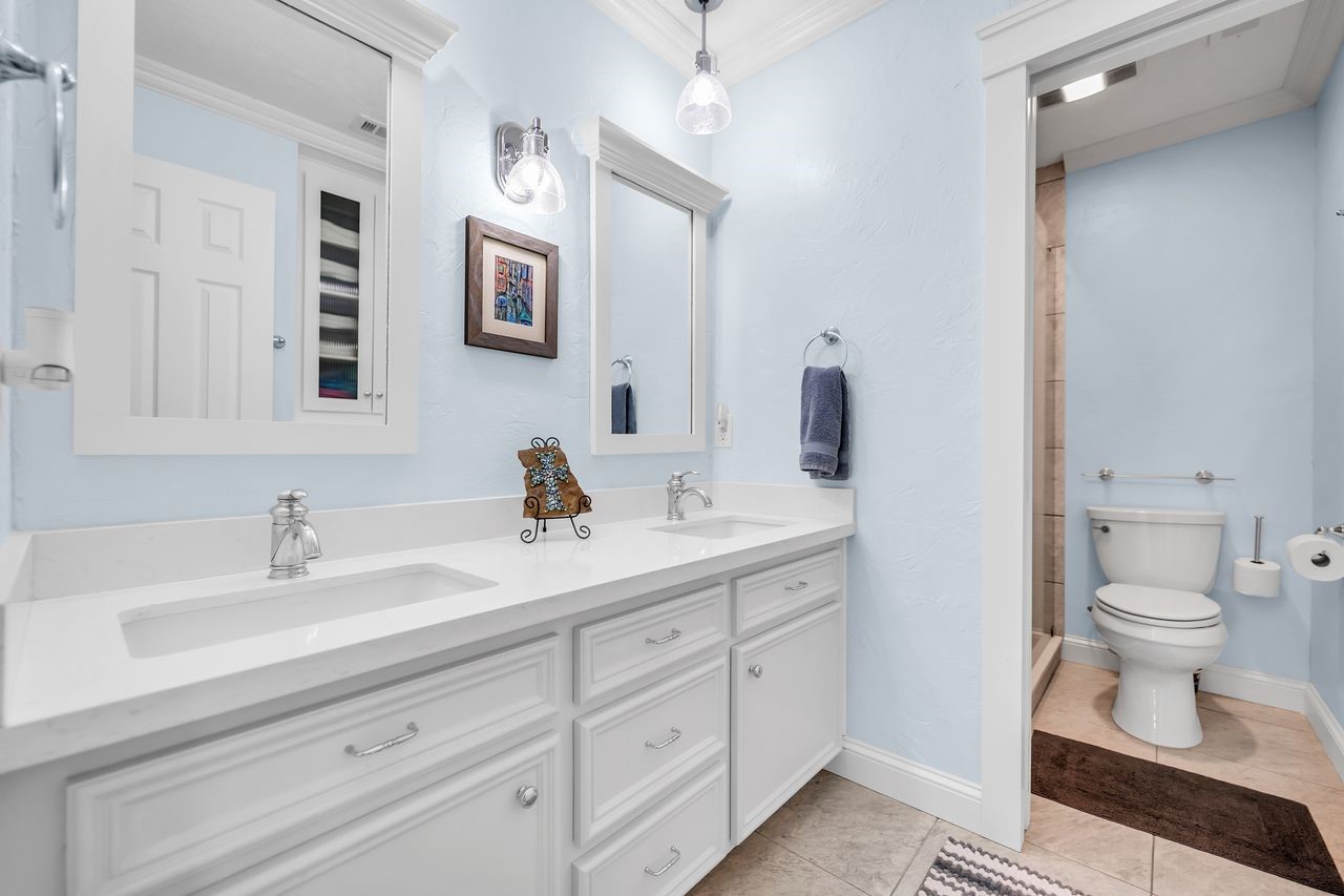 310 Cove Loop Coldspring, TX 77331 - Photo 25 of 48 Secondary bathroom has a double vanity, built in linen storage and separate toilet room with shower.