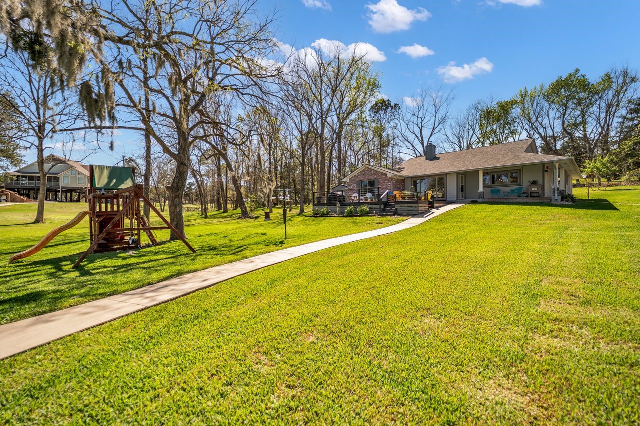 310 Cove Loop Coldspring, TX 77331 - Photo 36 of 48 Large, almost 1/2 an acre lot. This is the sidewalk leading down to the boat house.