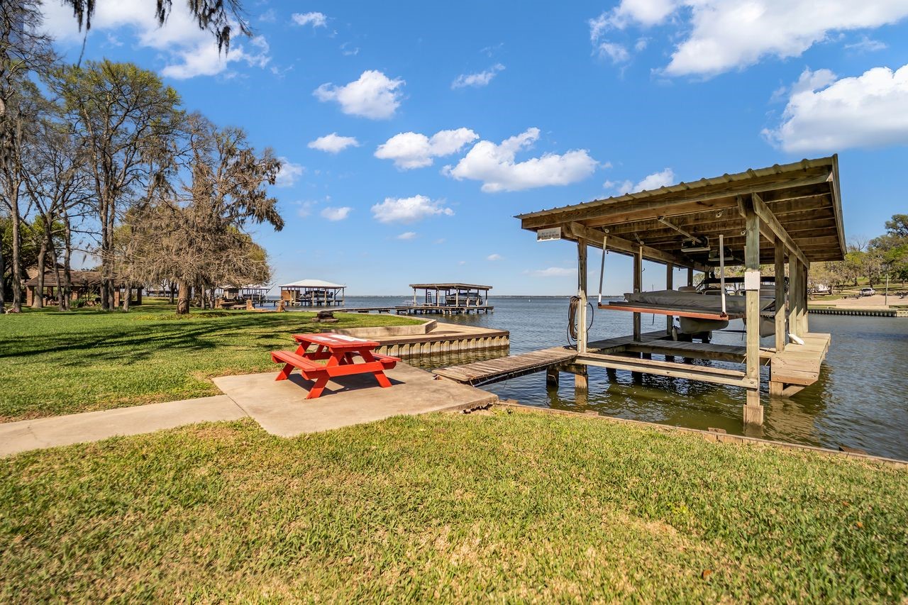 310 Cove Loop Coldspring, TX 77331 - Photo 39 of 48 A nice picnic area at the boat house. Note, pontoon boat conveys with home.