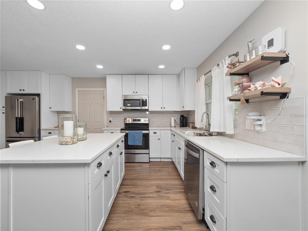 2733 Middle Street Orlando, FL 32807 - Photo 9 of 23 a kitchen with kitchen island granite countertop lots of counter top space and sink