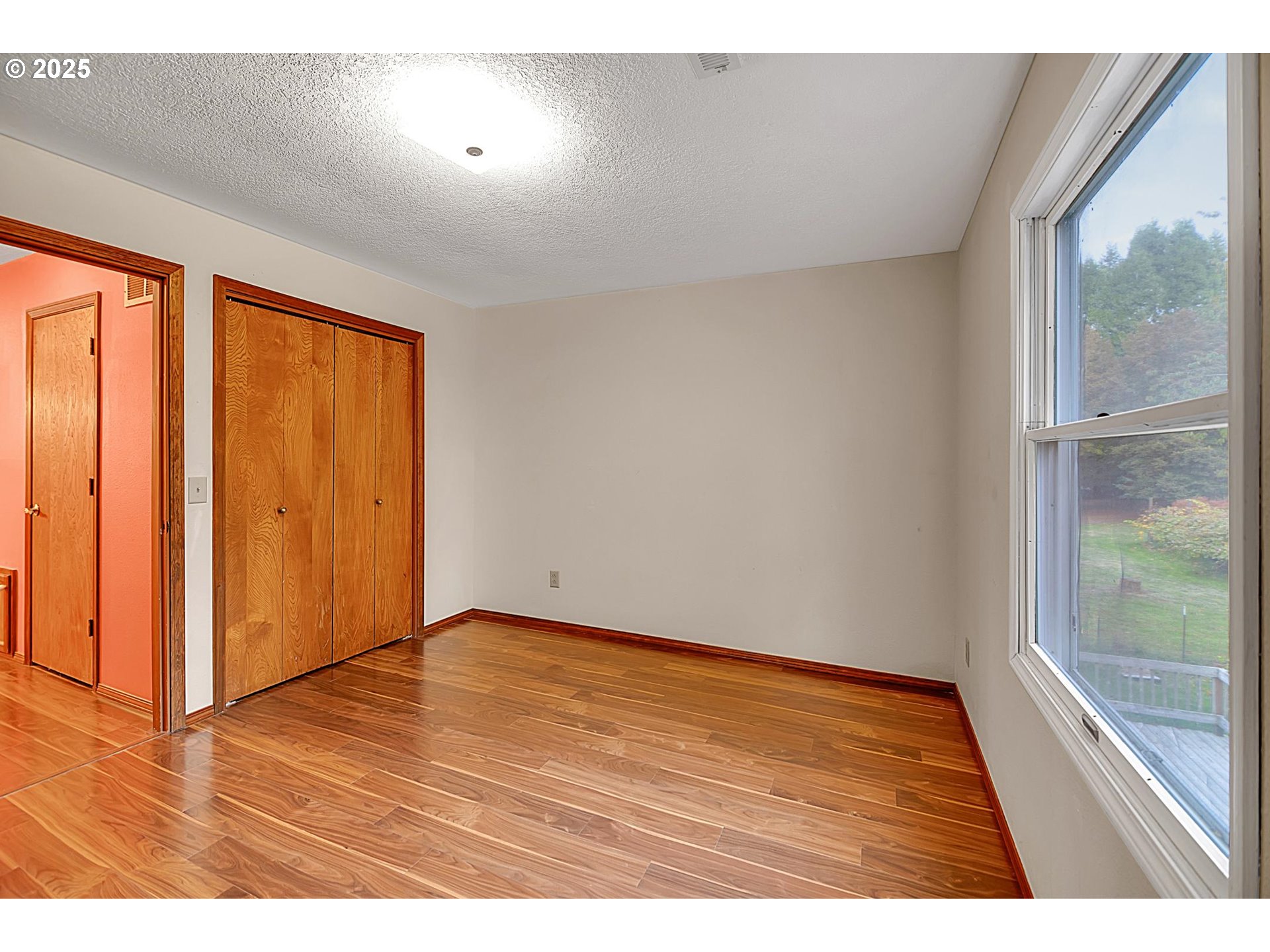 12077 Southeast Lusted Road Sandy, OR 97055 - Photo 15 of 44 a view of an empty room with wooden floor and a window