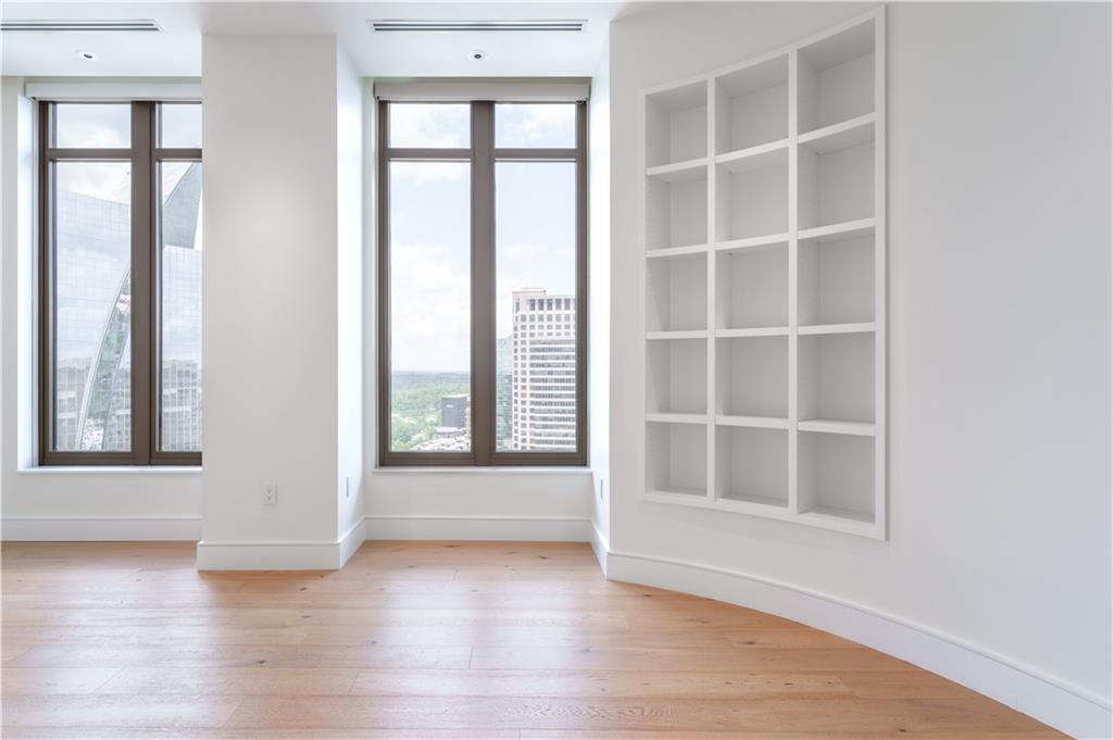 3376 Peachtree Road Northeast, Unit 34A Atlanta, GA 30326 - Photo 11 of 30 an empty room with wooden floor and windows