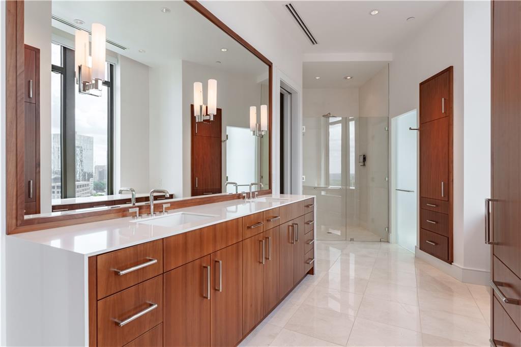 3376 Peachtree Road Northeast, Unit 34A Atlanta, GA 30326 - Photo 19 of 30 a spacious bathroom with a double vanity sink a large mirror and shower