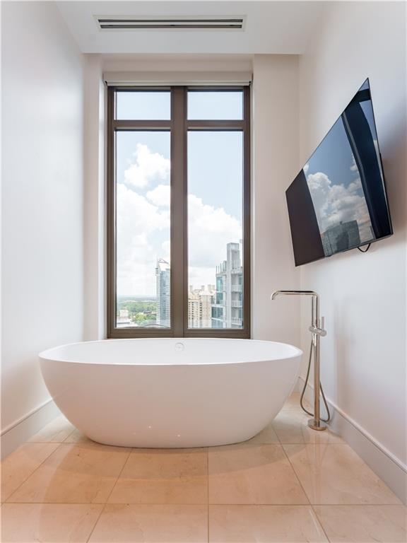 3376 Peachtree Road Northeast, Unit 34A Atlanta, GA 30326 - Photo 20 of 30 a white bath tub sitting next to a window