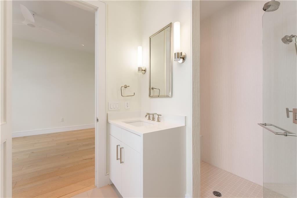 3376 Peachtree Road Northeast, Unit 34A Atlanta, GA 30326 - Photo 24 of 30 a bathroom with a sink a shower and a mirror