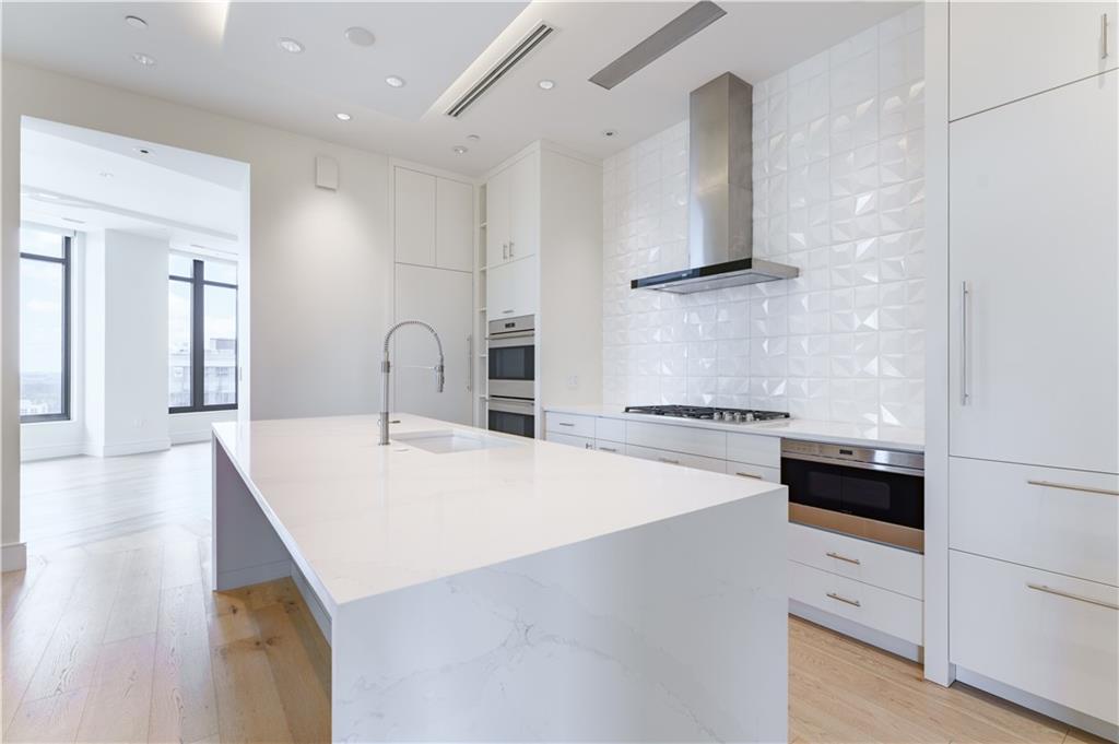 3376 Peachtree Road Northeast, Unit 34A Atlanta, GA 30326 - Photo 6 of 30 a kitchen with a stove a sink and a refrigerator